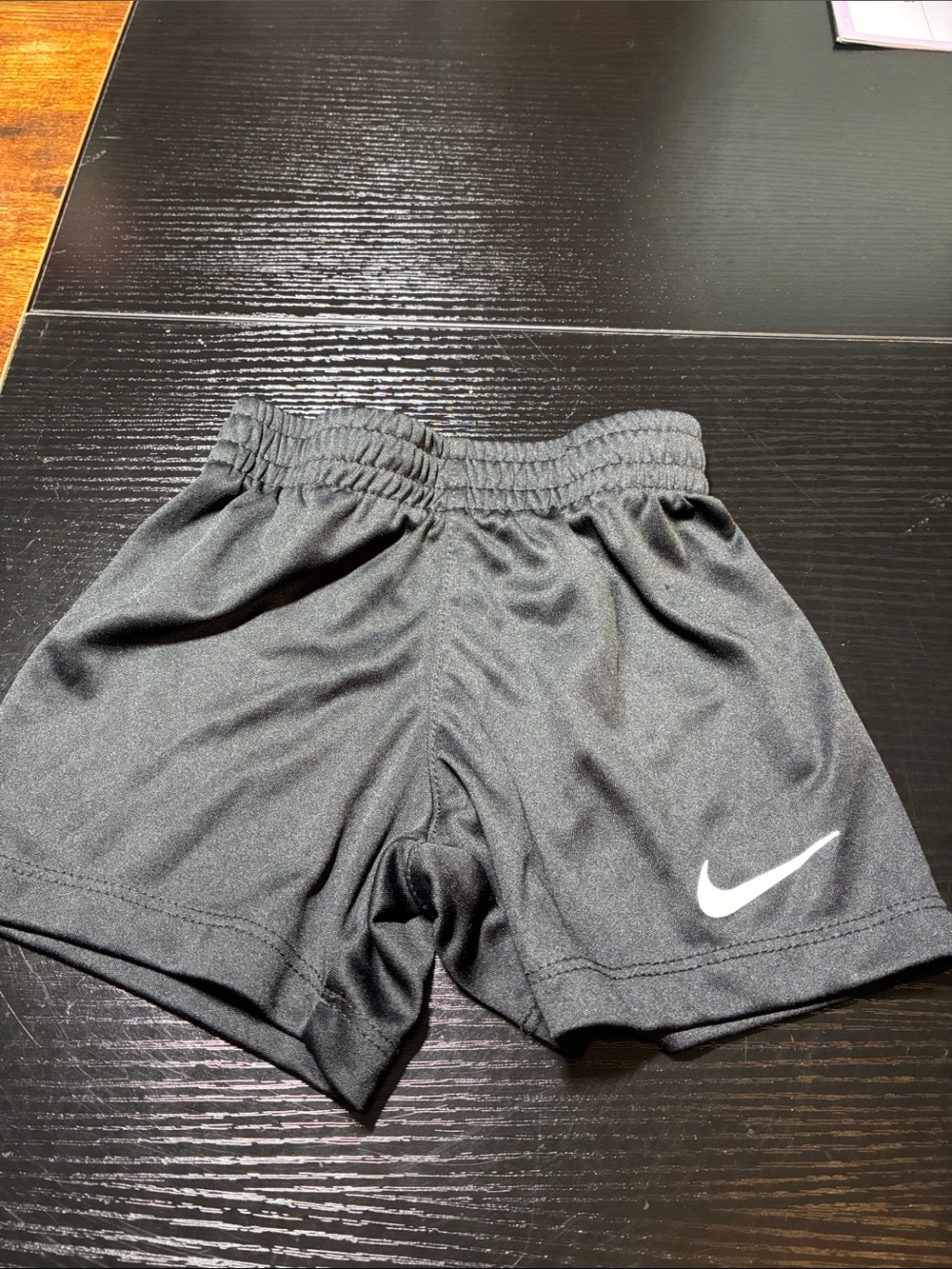 Nike Kids Black Athletic Shorts with White Swoosh Logo